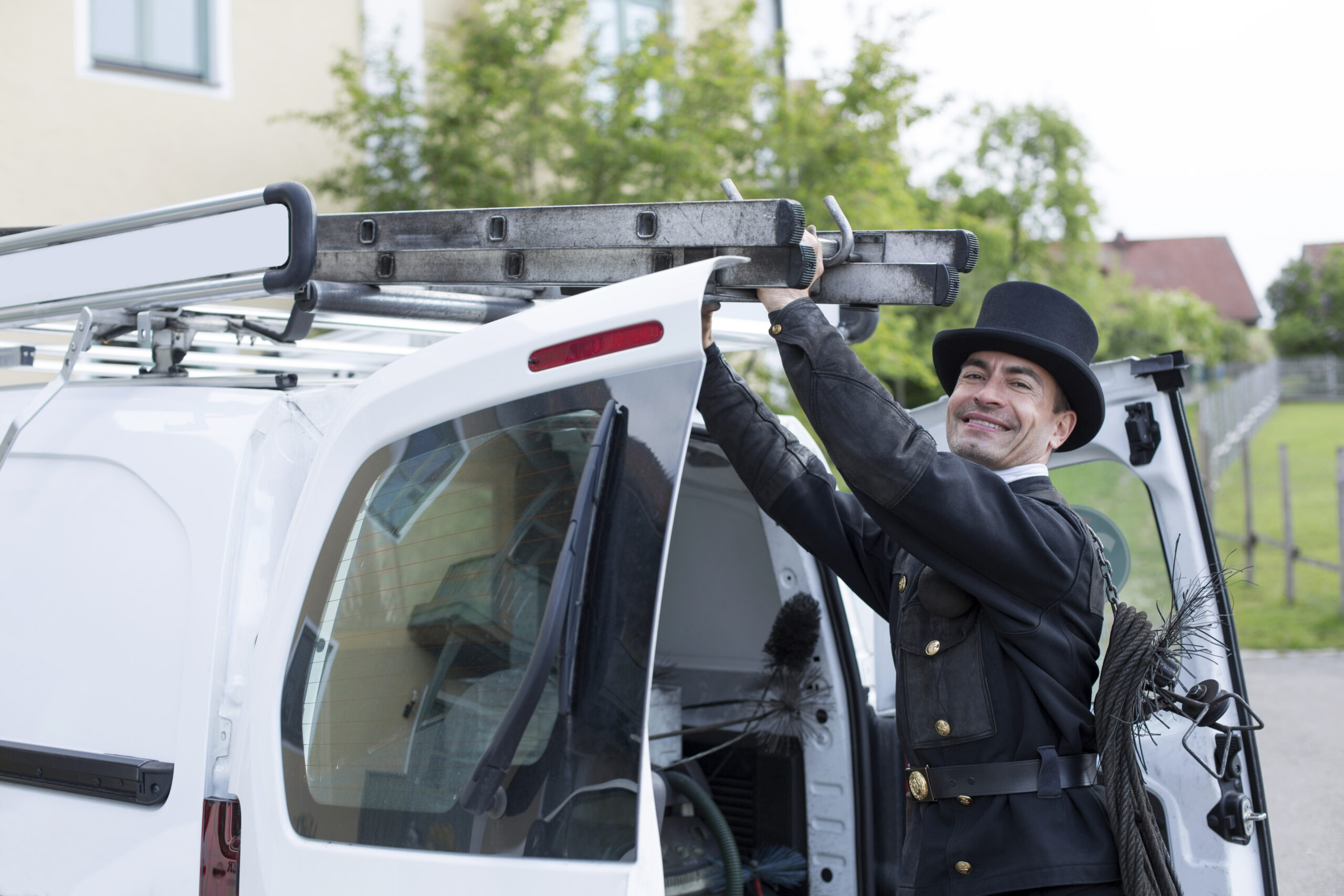 Portrait of smiling chimney sweep at his van revízia kominov, revízia komína, revízia komina ku kolaudacii